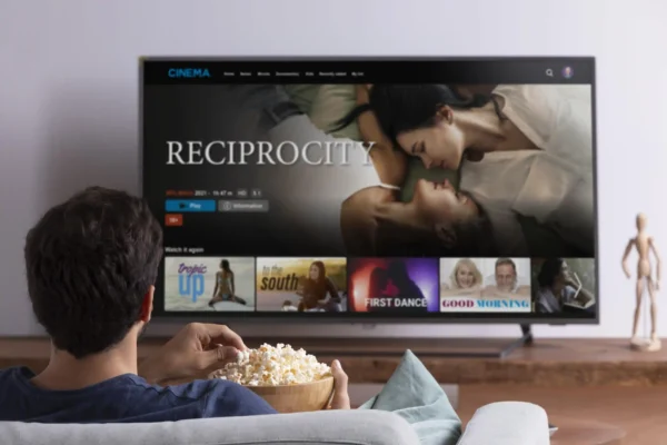 Man eating popcorn and watching television Sensei